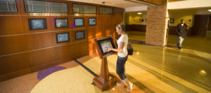 Woman using a touch-screen information kiosk