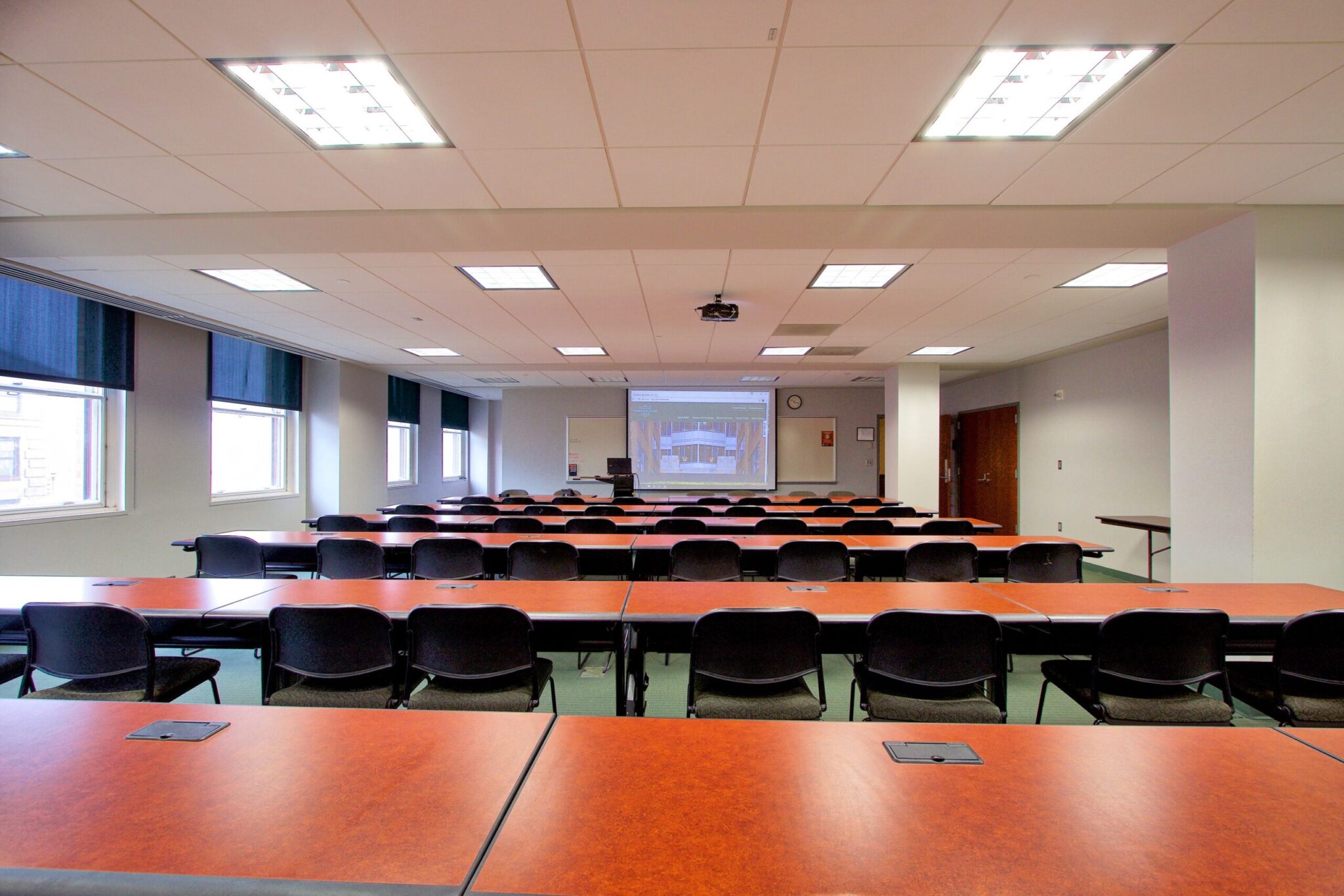 Room 408 classroom featuring rows of tables and chairs.